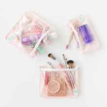 Load image into Gallery viewer, Bumkins Clear Travel Bag 3-Pack: Lace is neatly arranged on a white background with makeup, toiletries, and hair accessories inside.
