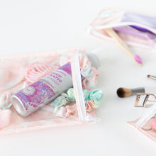 Load image into Gallery viewer, Close-up of Bumkins Clear Travel Bag 3-Pack: Lace on a white background with hair accessories and makeup inside.
