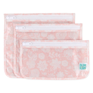 Bumkins Clear Travel Bag 3-Pack: Lace includes 3 TSA-compliant pouches made of pink waterproof fabric with a white lace design.