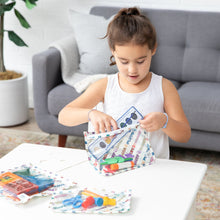 Load image into Gallery viewer, A girl in a white dress packs art supplies into Bumkins Clear Travel Bag 3 Pack: Mickey &amp; Friends Varsity at a table in the living room.
