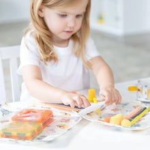 Load image into Gallery viewer, A child explores toys and art supplies in Bumkins Clear Travel Bag 3-Pack: Winnie and Friends at a white table.
