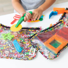 Load image into Gallery viewer, Close-up of child playing with colorful clay and tools next to Bumkins Clear Travel Bag 3-Pack: Super Mario™ Mashup with magnetic blocks.
