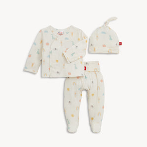 Magnetic Me Kimono Lullaby Pink set includes a soft modal wrap shirt, pants, and hat with pastel suns, clouds, and giraffes.