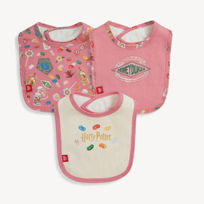 Magnetic Me, 3-Pack Bib HP Honeydukes: three Harry Potter candy themed bibs with magnetic closures in pink and cream; made of TENCEL modal.
