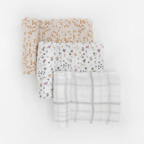 Little Unicorn Cotton Swaddle Set, Garden Bees: 3 muslin blankets—brown dot, floral, & gray grid—for swaddling or snuggling.