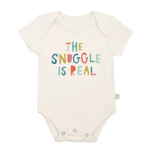 Load image into Gallery viewer, Finn and Emmas Organic Bodysuit, Snuggle Is Real, is cream-colored with colorful text: THE SNUGGLE IS REAL on the front.
