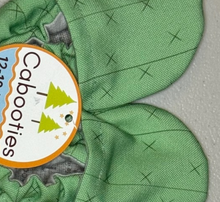 Load image into Gallery viewer, Close-up of green Cabooties, Cactus Spines baby shoes with elastic ankle and cactus designs on the label.
