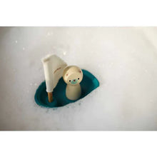 Load image into Gallery viewer, The PlanToys Sailing Boat with Polar Bear drifts through white foamy bubbles.
