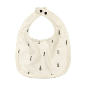 Organic Reversible Bib: cream bib with tree pattern and snap closure.