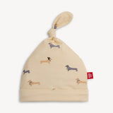 Magnetic Me Beenie Von Weinie Hat: cream modal, dachshund print, top knot & red tag—ideal for newborn's coming home outfit.