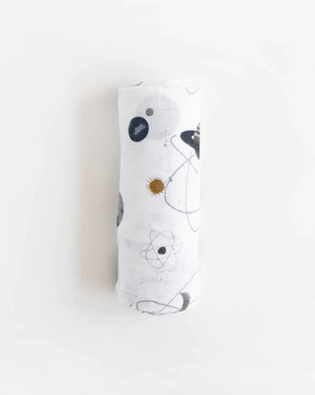 The Little Unicorn Cotton Swaddle, Planetary is a lightweight and breathable muslin adorned with planets and celestial designs.