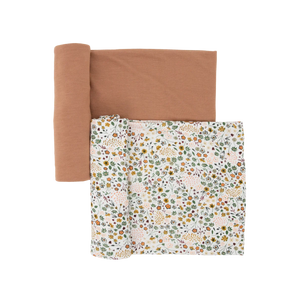 Little Unicorn Stretch Knit Swaddle 2 Pack: Pressed Petals—one brown, one white with floral & cheetah print, both soft stretch knit.