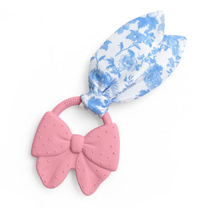 Itzy Ritzy Crinkle Teether in Pink Bow: silicone ring with easy-grip handle and blue/white floral crinkle fabric ears.