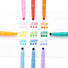 Load image into Gallery viewer, Confetti Stamp Markers by OOLY form a colorful circle, crafting hearts, stars, waves, and dots on white paper.
