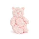 Jellycat Leola Bear Large, a soft pink plush, sits upright on white—playfully inspired by South London studio fashion designs.