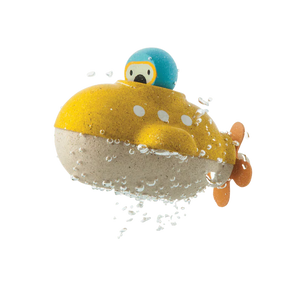 PlanToys Wooden Submarine Bath Toy in yellow and blue, with a propeller and cute face, glistens with water droplets.