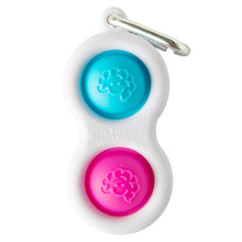 Load image into Gallery viewer, The Simpl Dimpl by Fat Brain Toy Co is a white fidget keychain with a carabiner and two brain-design buttons, one blue and one pink.
