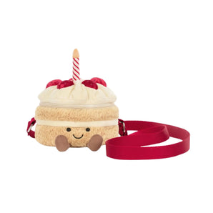 Jellycat Amuseables Birthday Cake Bag: plush, smiling face, red strap, candle, strawberry details.