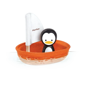 PlanToys sustainable Sailing Boat, Penguin is crafted from PlanWood and features an orange sailboat with a white PlanToys sail.