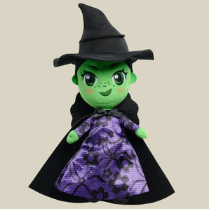 Wicked 8 Inch Plush: green witch plush doll wearing purple lace-print dress with black cape and black hat.